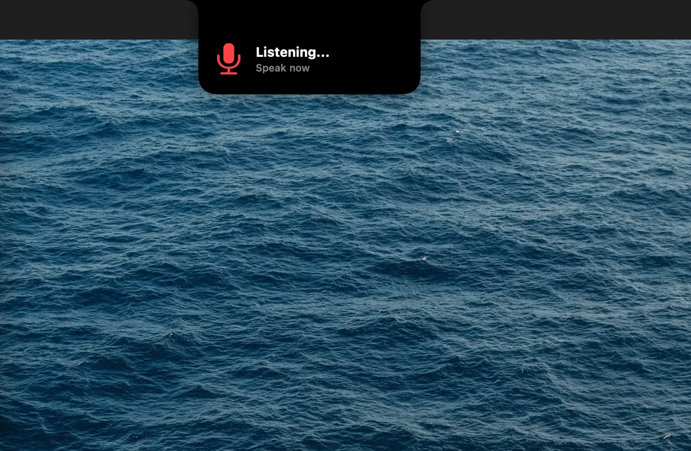 JustScribe's recording indicator dropping from the MacBook notch: a red microphone and the words Listening, speak now
